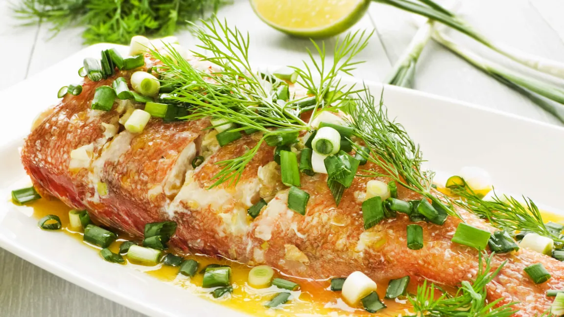 Der Klassiker: Gemüsefenchel mit Fisch, hier mit Seebarsch. Foto: Depositphotos